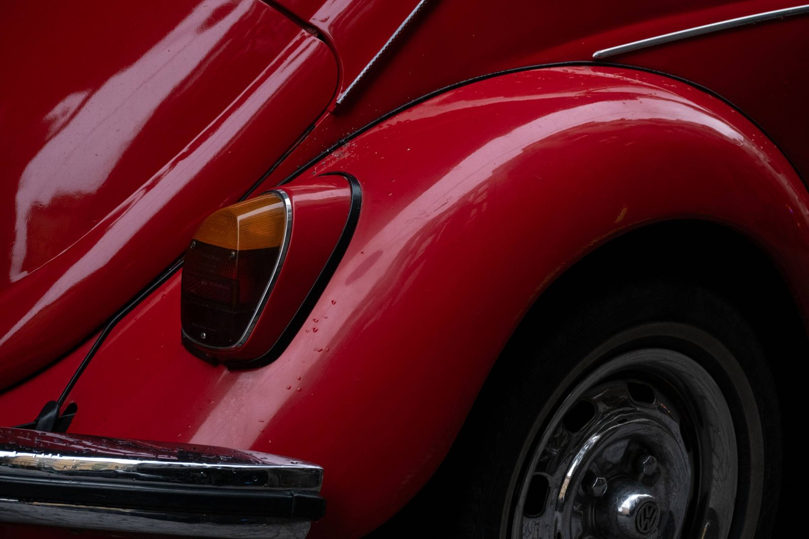 Close-up of a red Volkswagen Beetle body panel